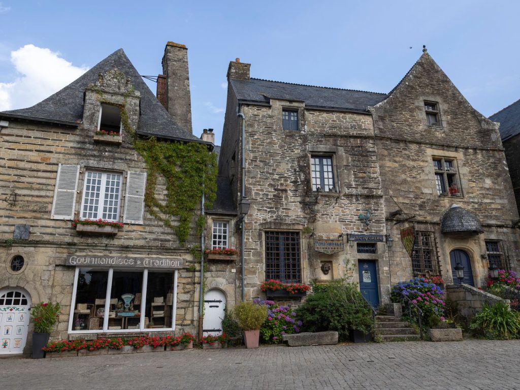Quaint stone structures in Rochefort-en-Terre, showcasing Breton architecture.
